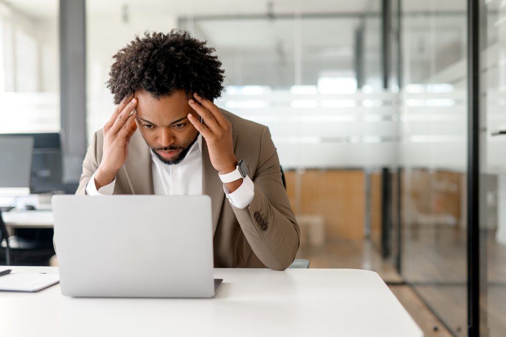 man stressed looking at laptop